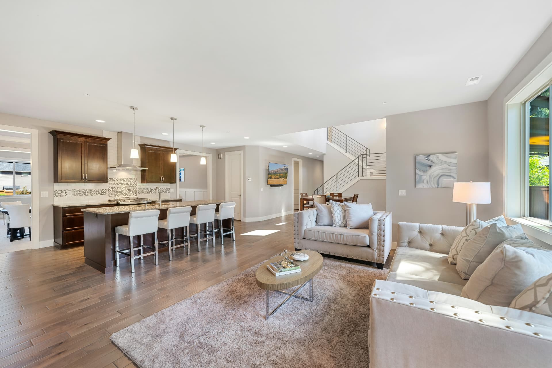 Open lower level finished with light wood-look luxury vinyl flooring