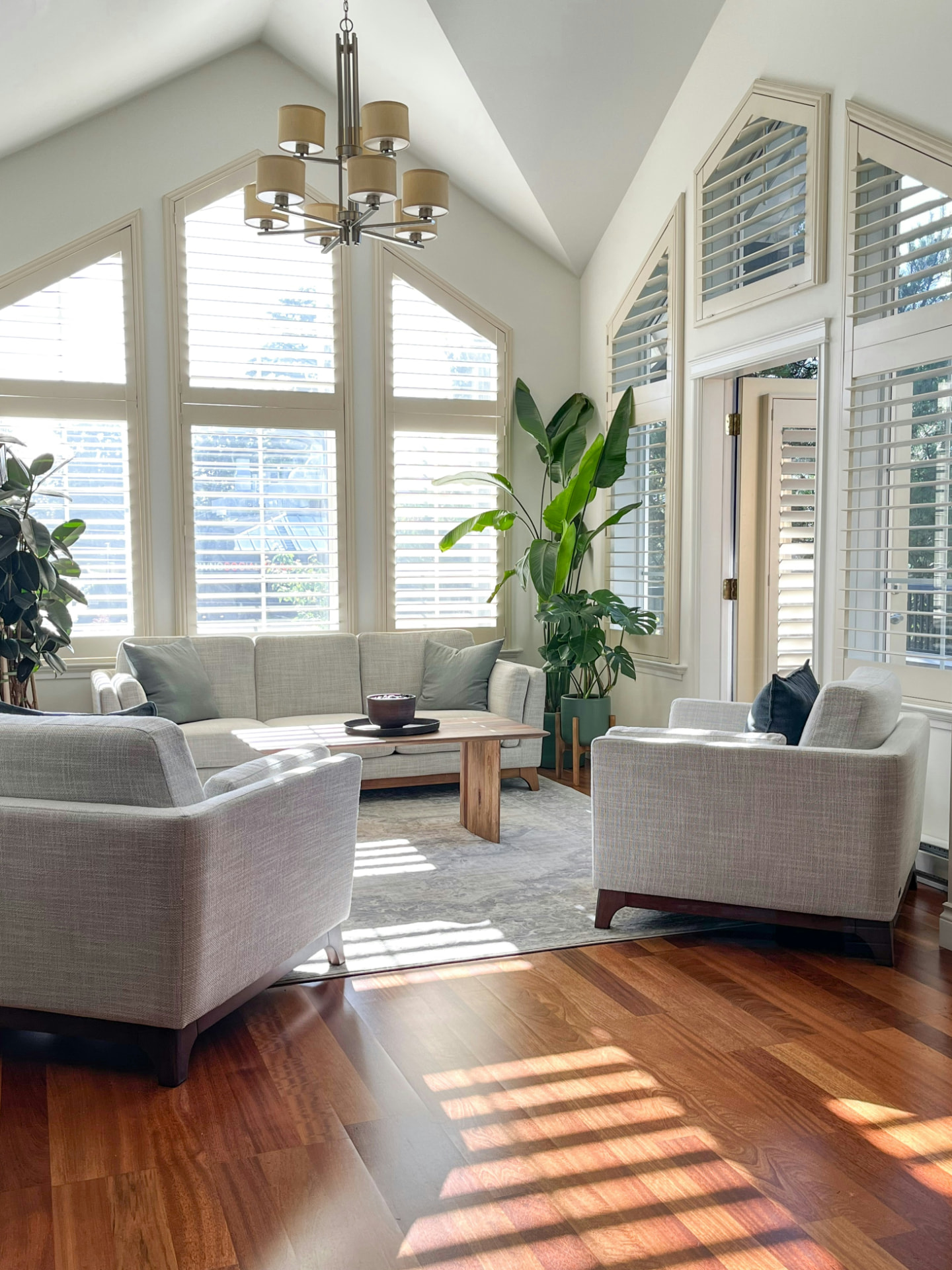 Sunlit family room with warm-toned solid hardwood floors